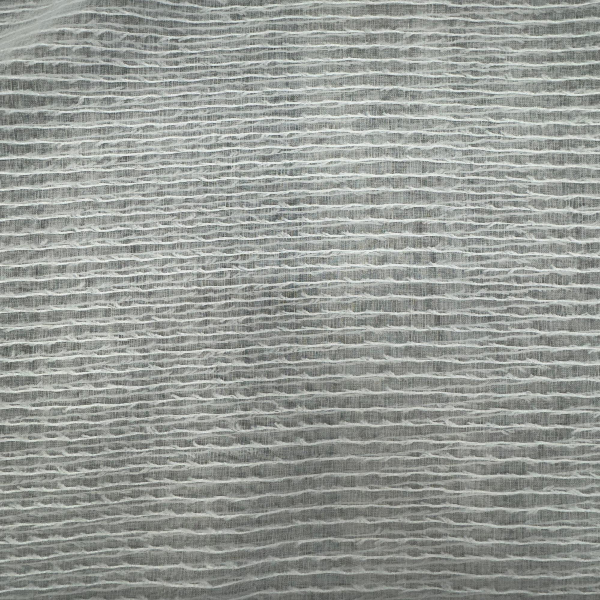 Close-up of sheer white fabric with a textured pattern