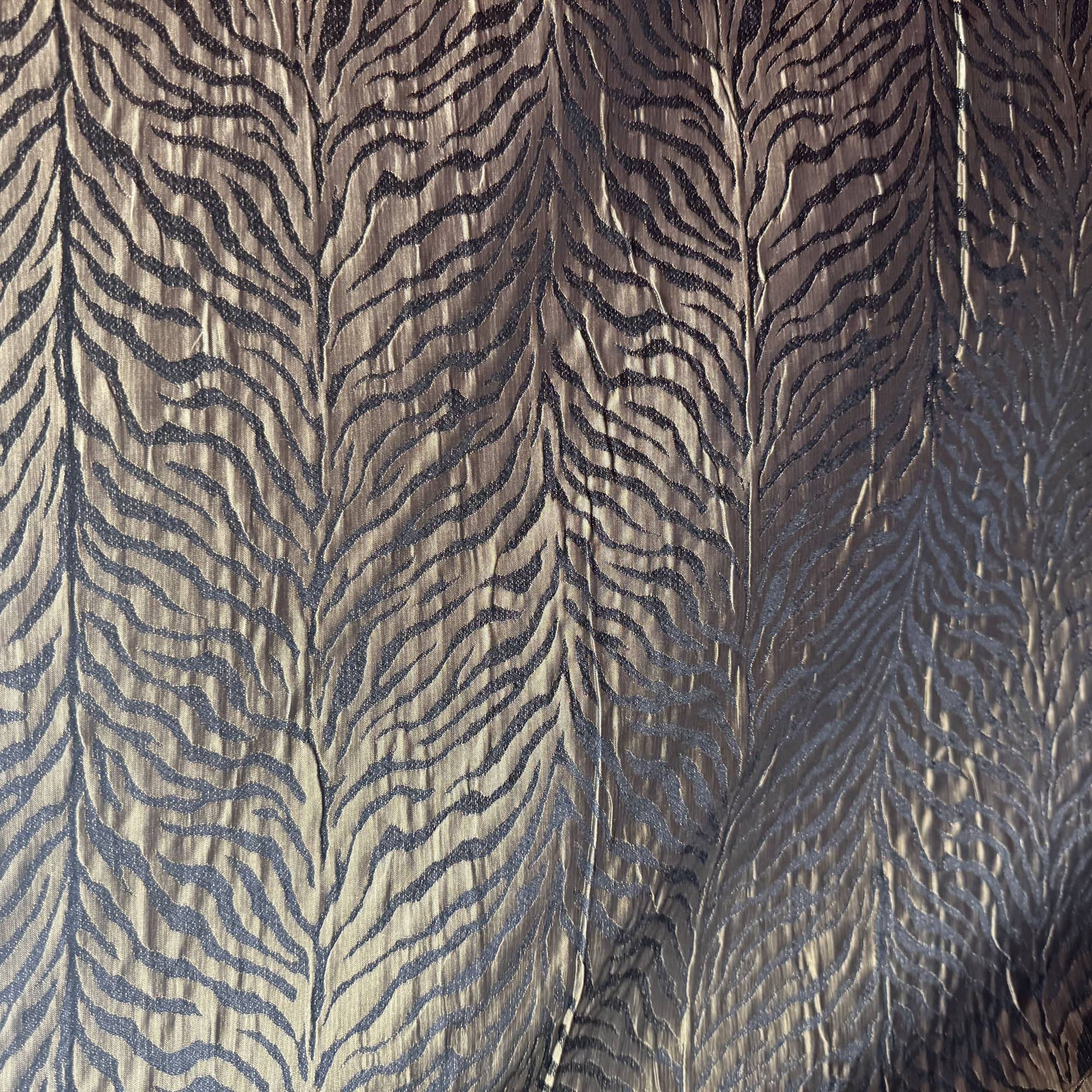 Textured fabric with a zebra stripe pattern in brown and gray.