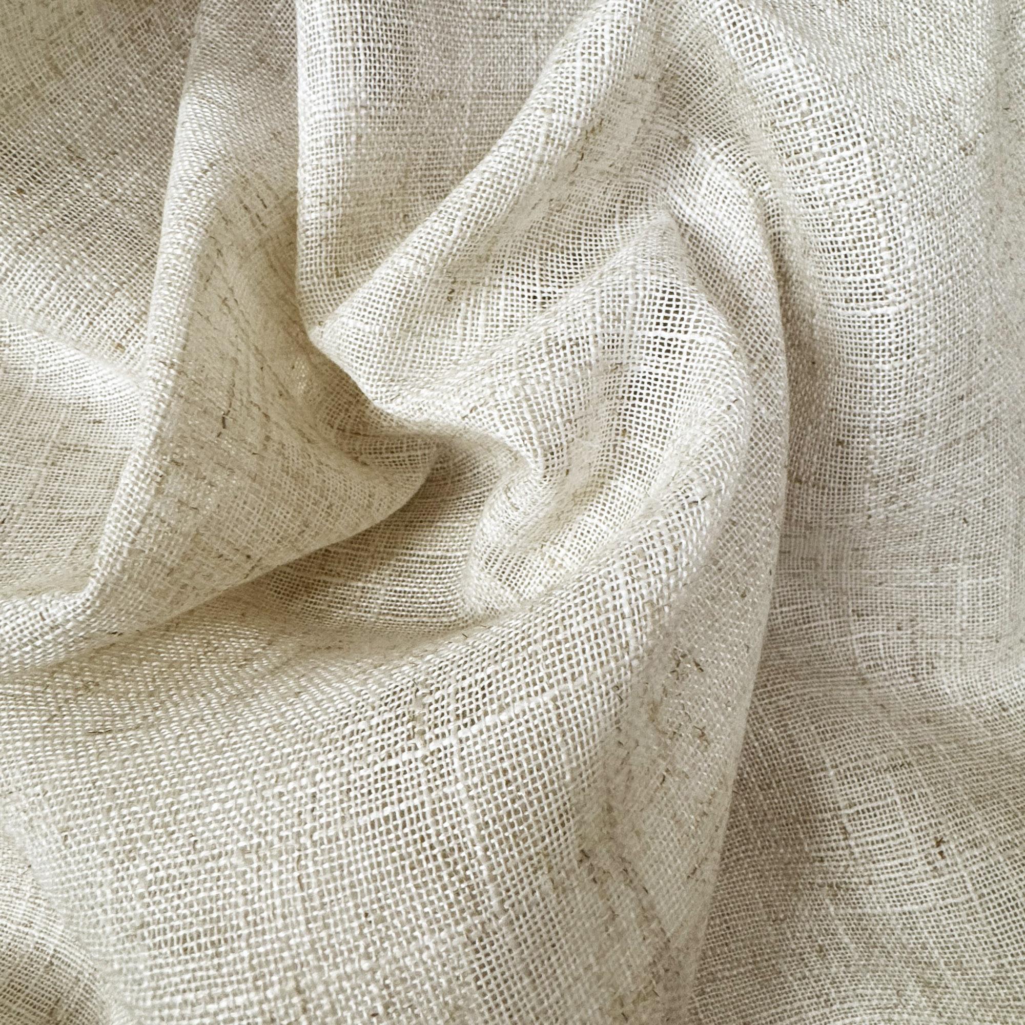 Natural lightweight sheer fabric with a refined texture, ideal for curtains and drapery. High-quality and stylish for any space.