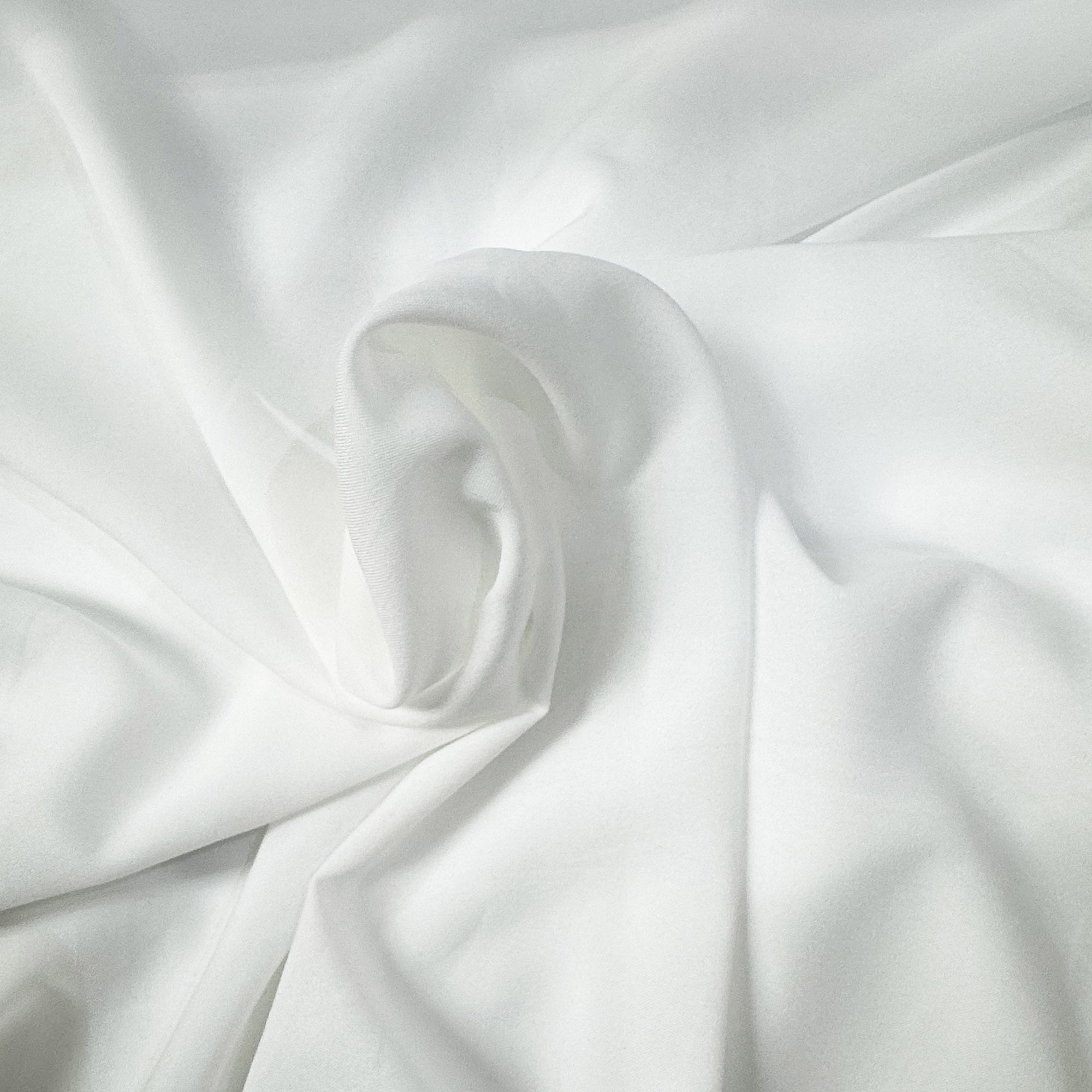 Ivory lightweight sheer fabric with a refined texture, ideal for curtains and drapery. High-quality and stylish for any space.
