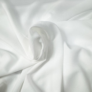 Ivory lightweight sheer fabric with a refined texture, ideal for curtains and drapery. High-quality and stylish for any space.