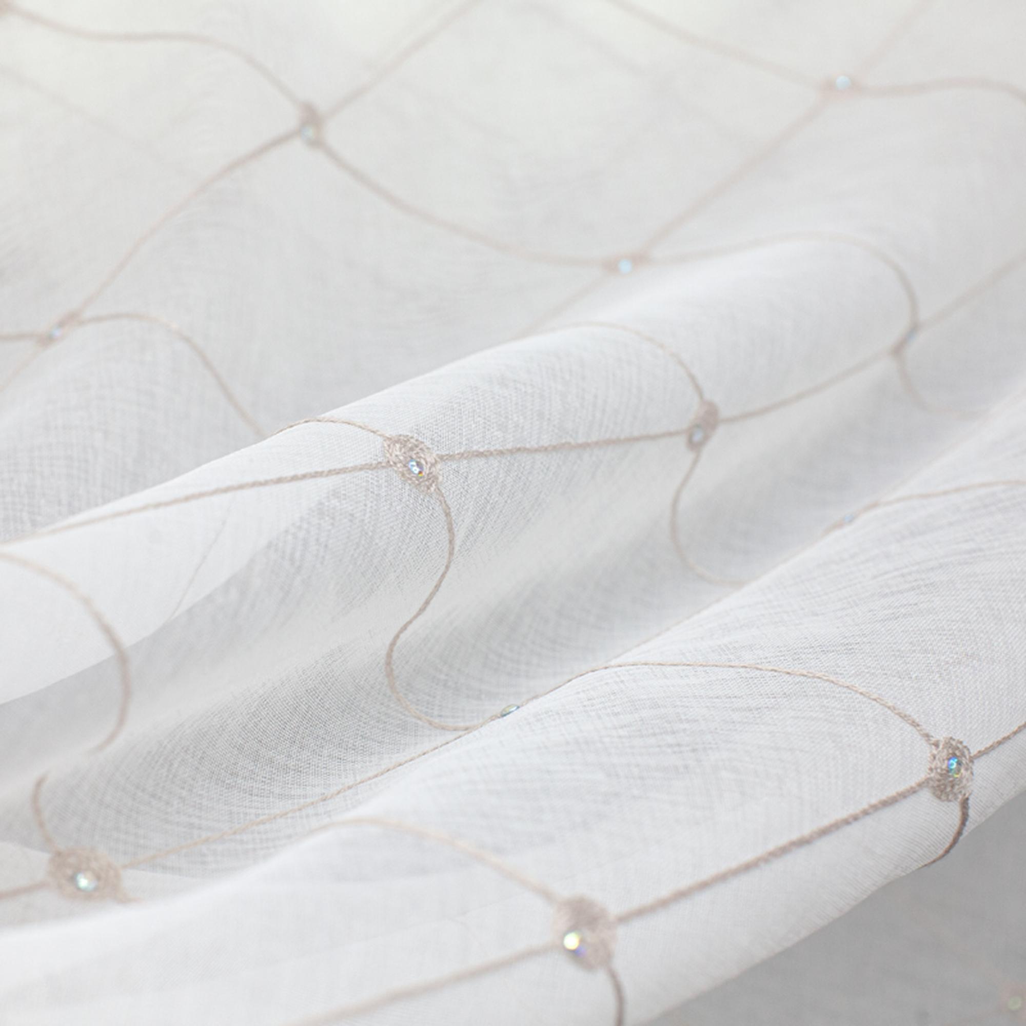 Cream lightweight sheer fabric with a refined texture, ideal for curtains and drapery. High-quality and stylish for any space.