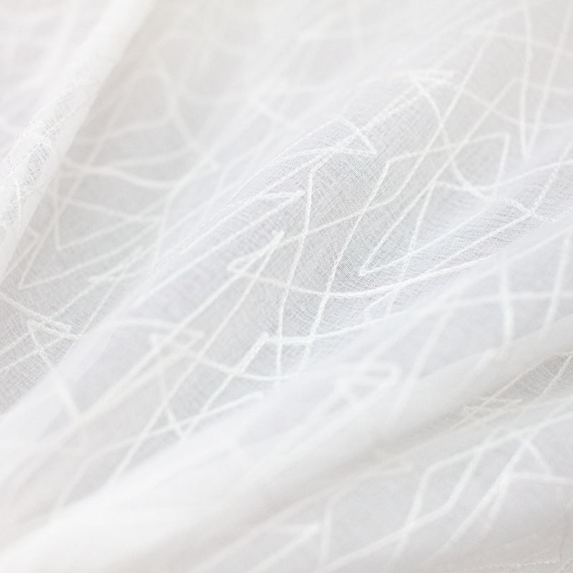 Saturn fabric in color White showcasing fabric zigzag embroidered sheer drapery & curtain fabric.
