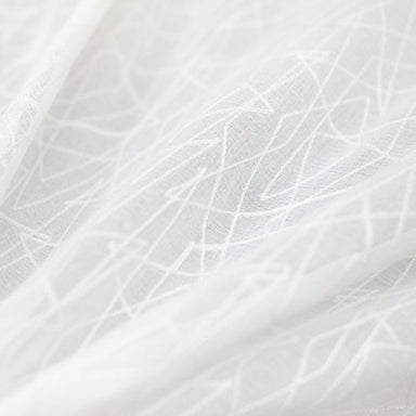 Saturn fabric in color White showcasing fabric zigzag embroidered sheer drapery & curtain fabric.